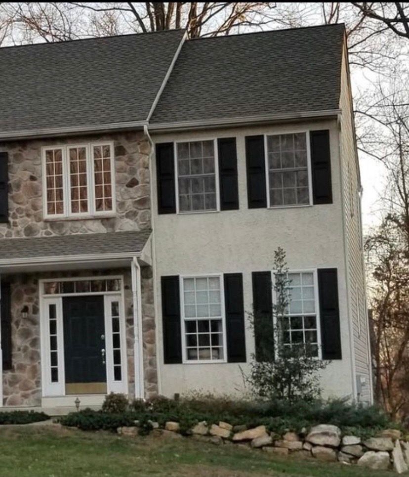 A white house with black shutters on the windows