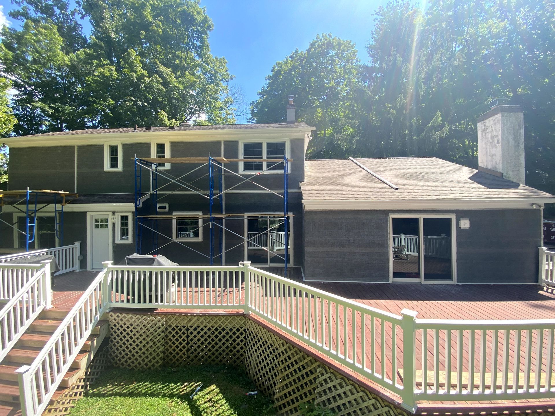 A house with scaffolding around it is being painted