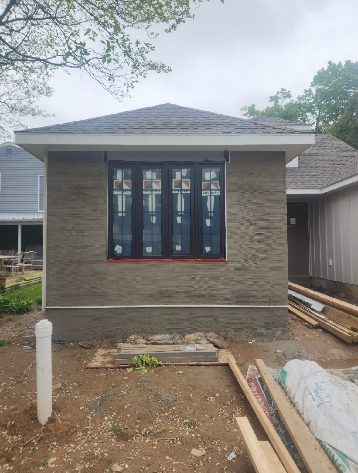 A house that is being built with a lot of windows