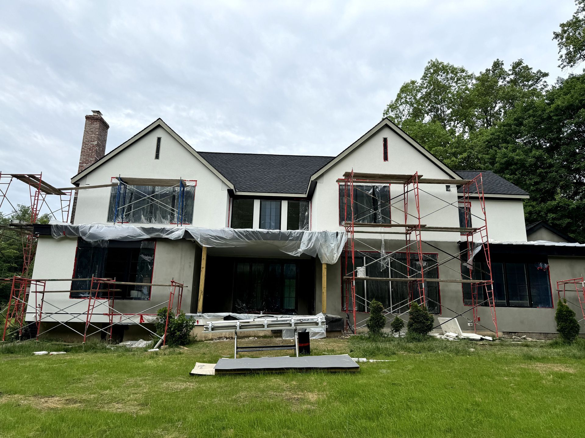 A large house is being built with scaffolding around it.