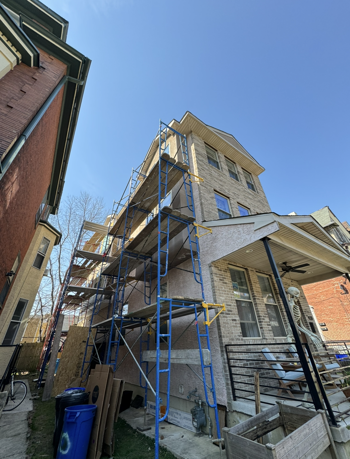 A house is being remodeled with scaffolding on the side of it.