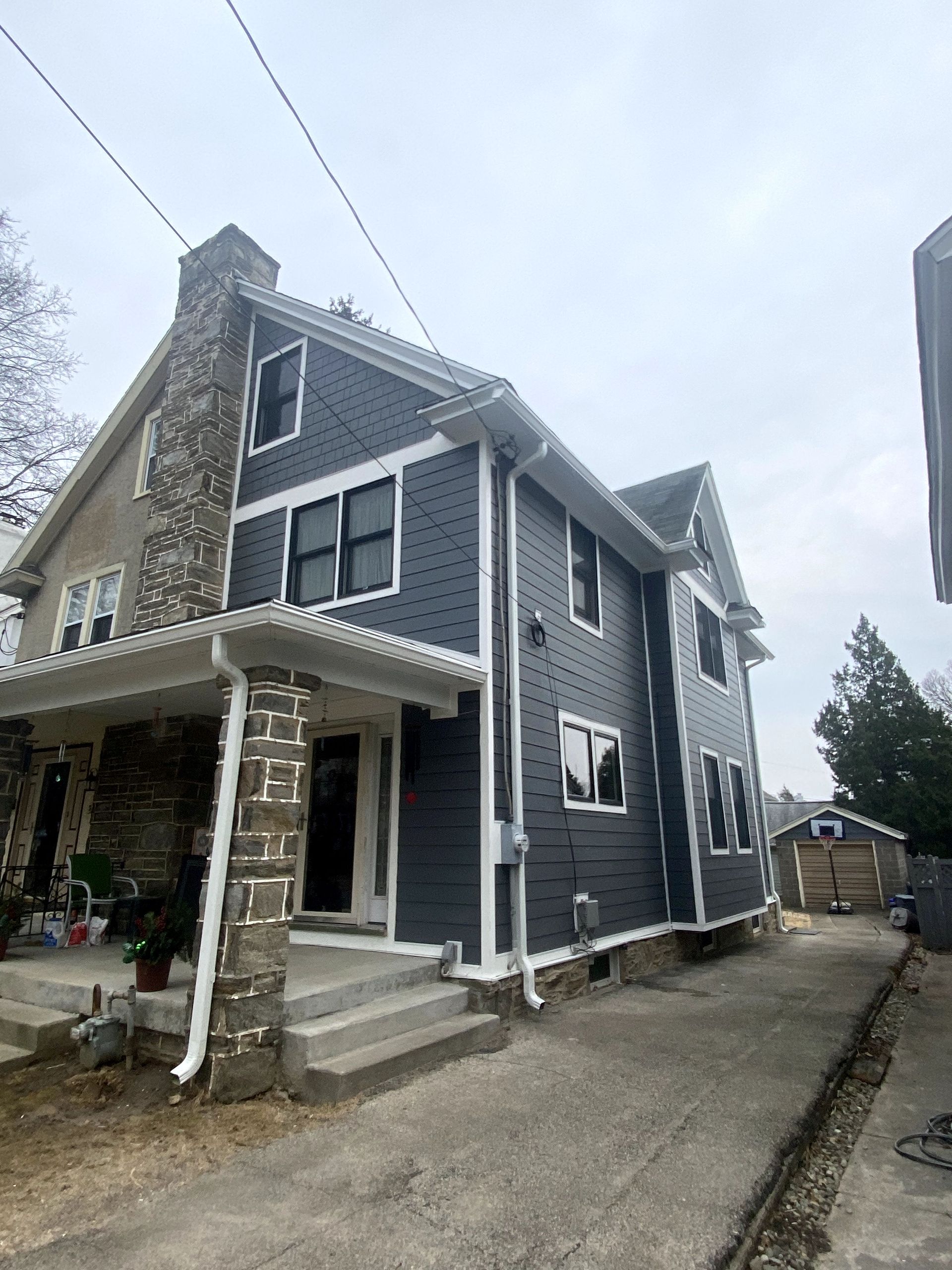 A large house with a lot of windows and a chimney on the side of it.