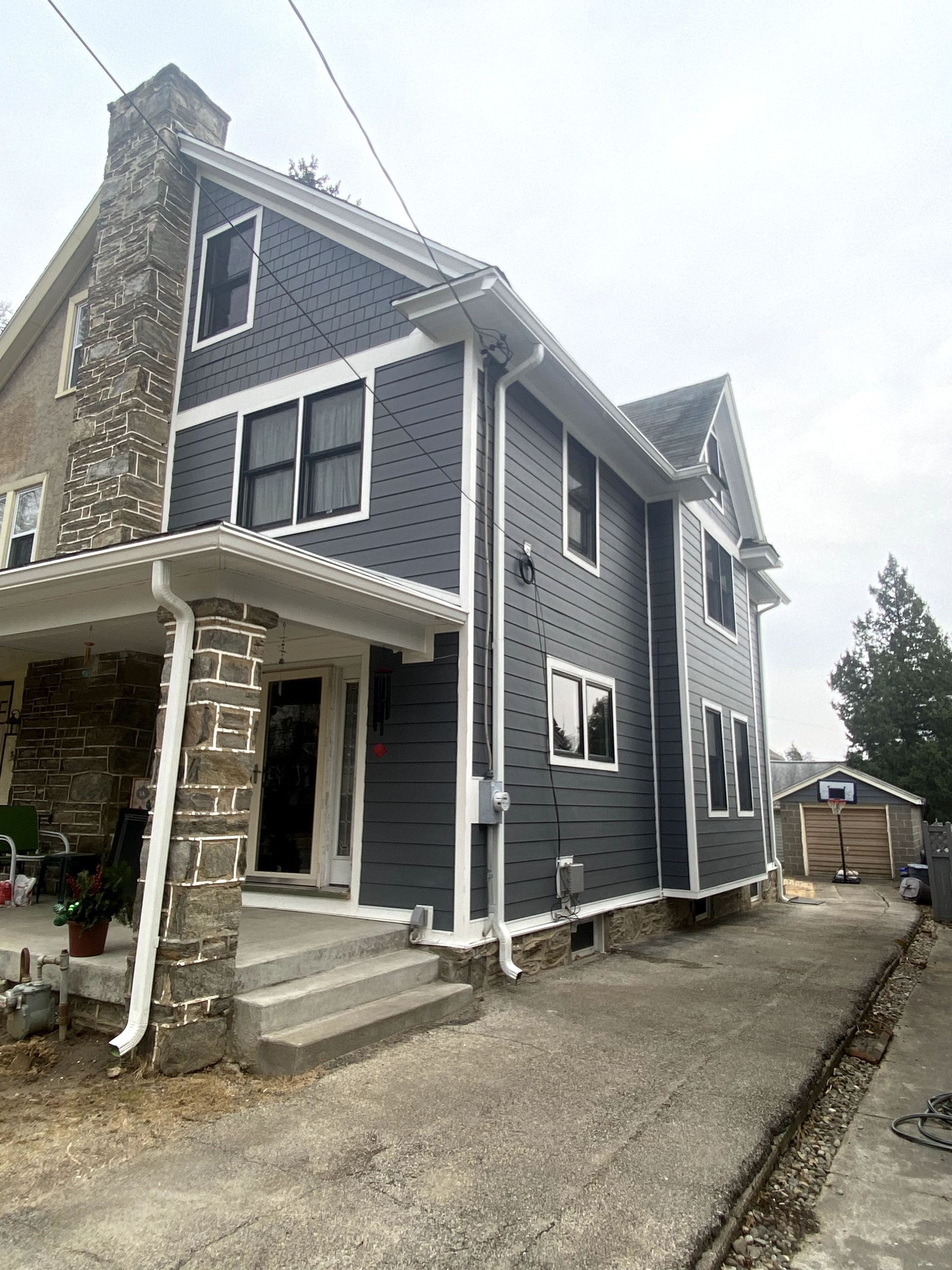 A large house with a lot of windows and a porch.