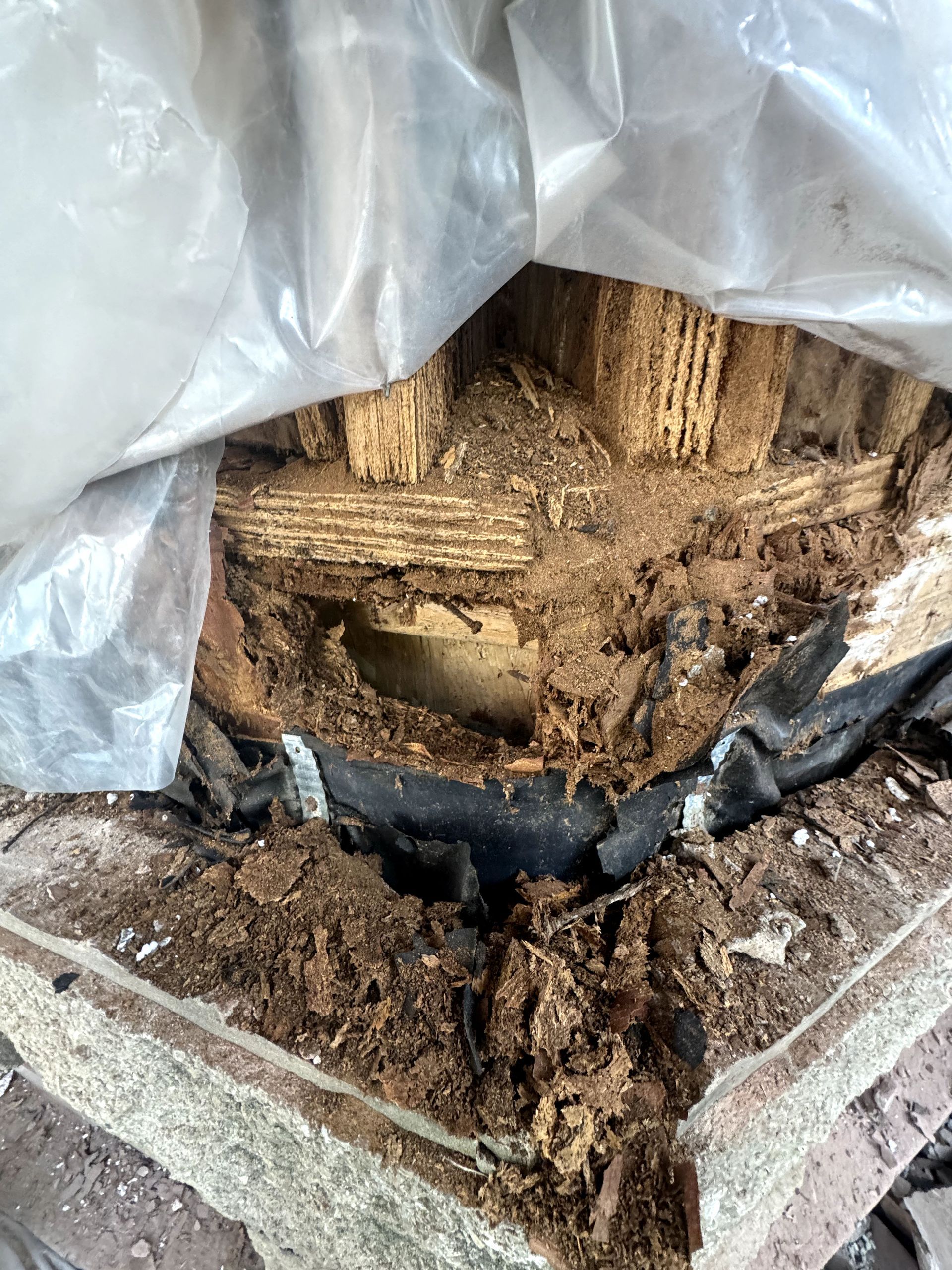 A piece of wood is sitting on top of a pile of dirt.