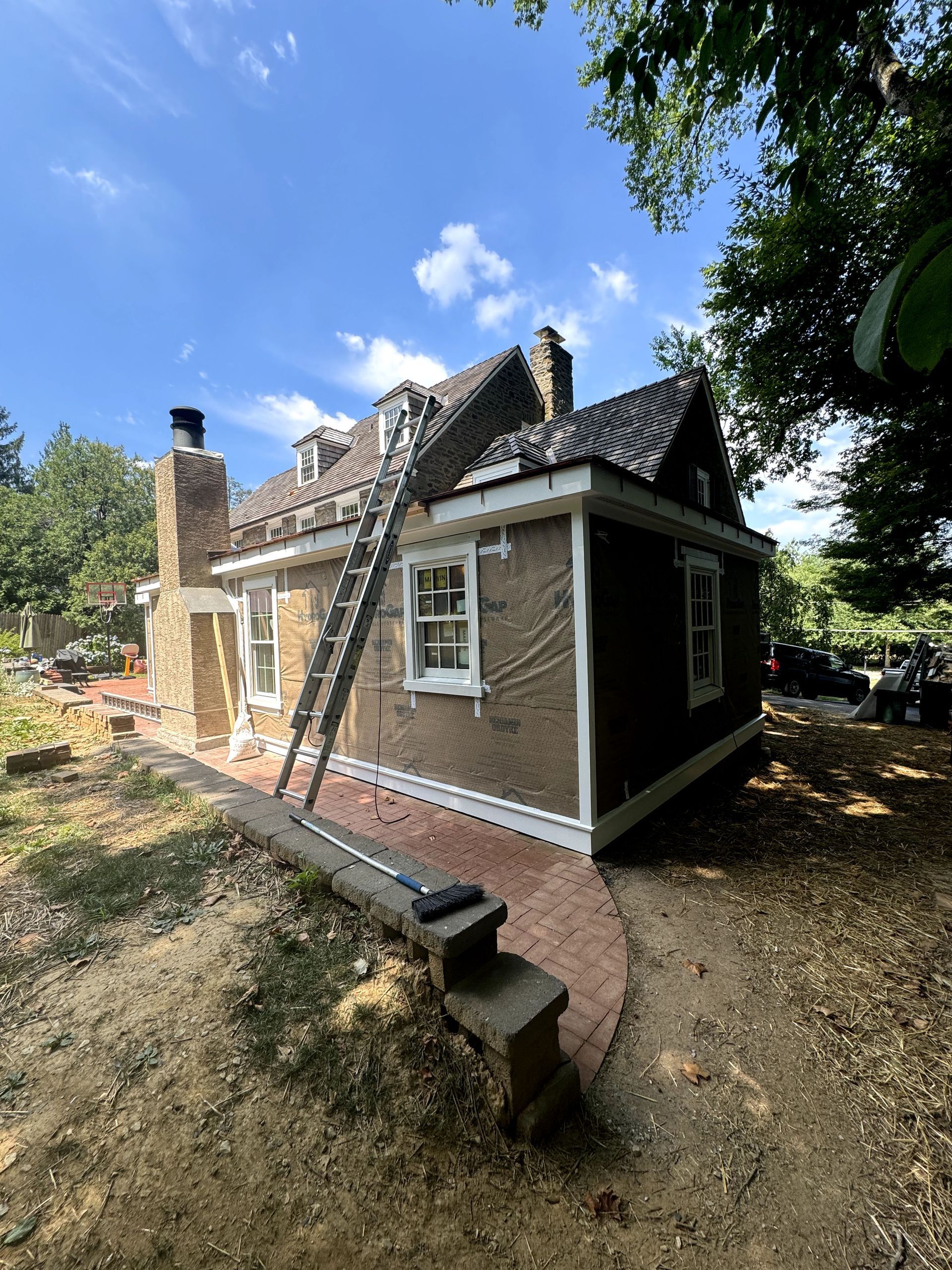 A house with a ladder attached to the side of it.