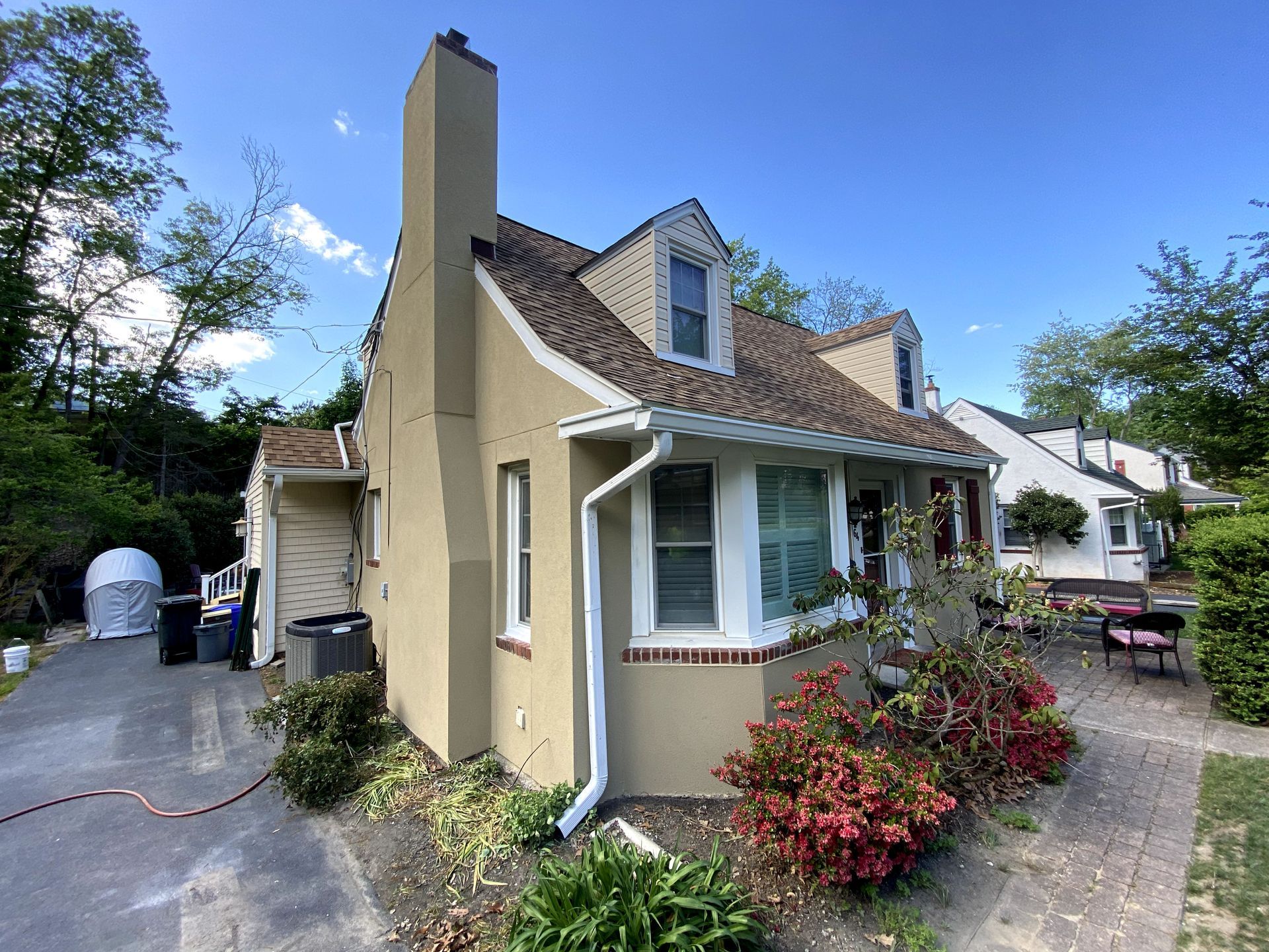 A small house with a chimney on the side of it