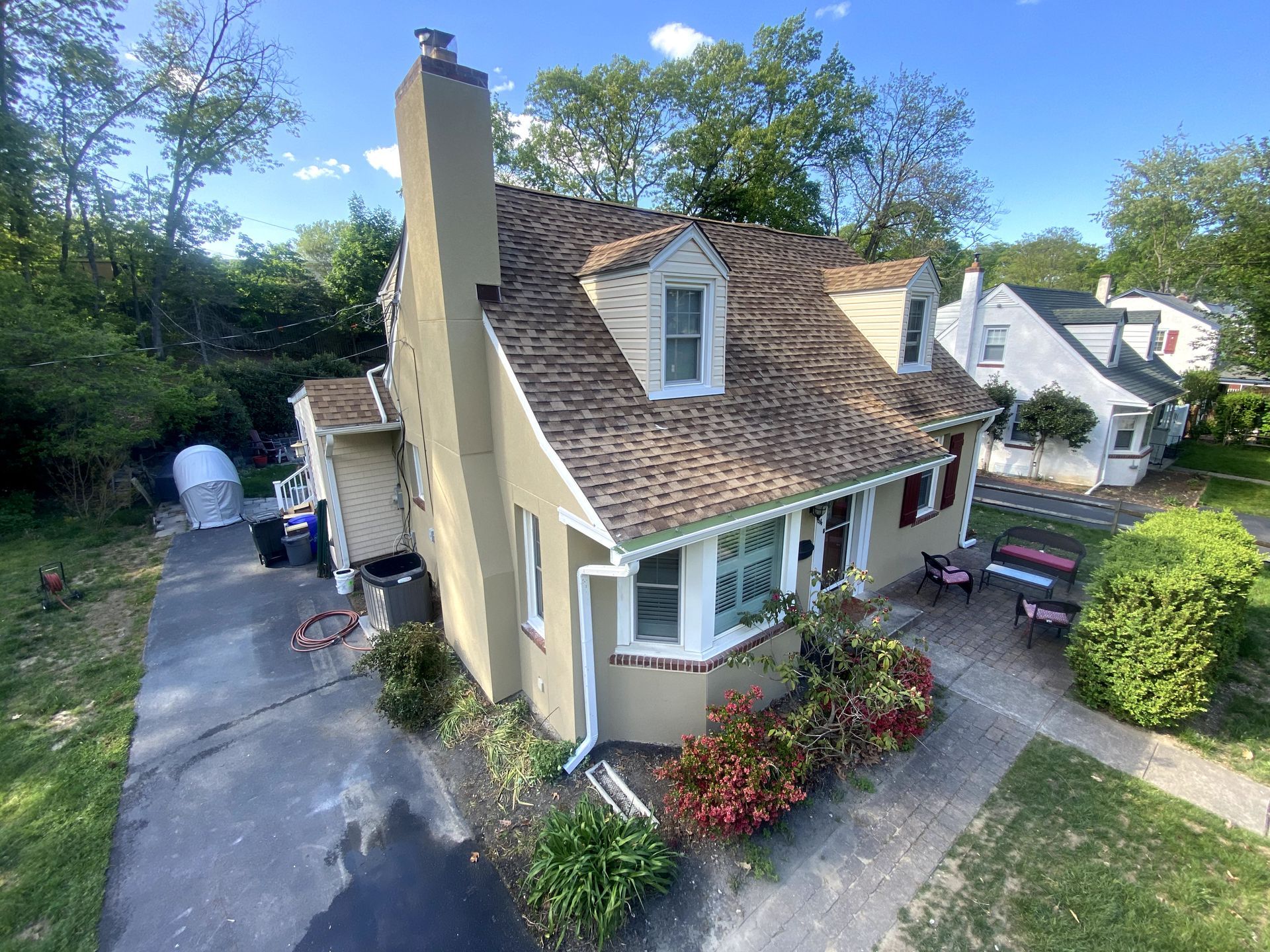An aerial view of a house with a new roof.