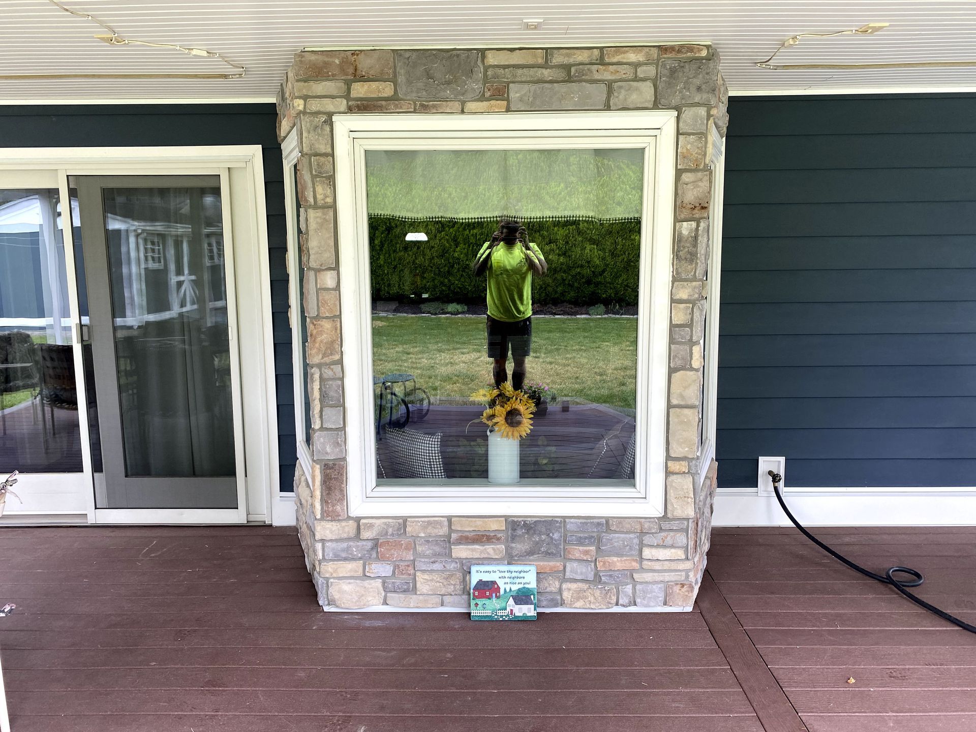 A woman is taking a picture of herself in a window.