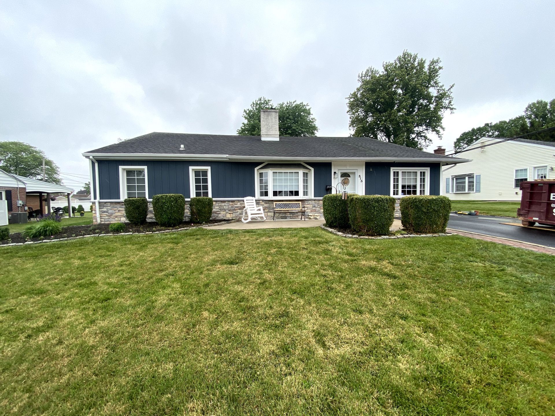 A house with a large lawn in front of it.