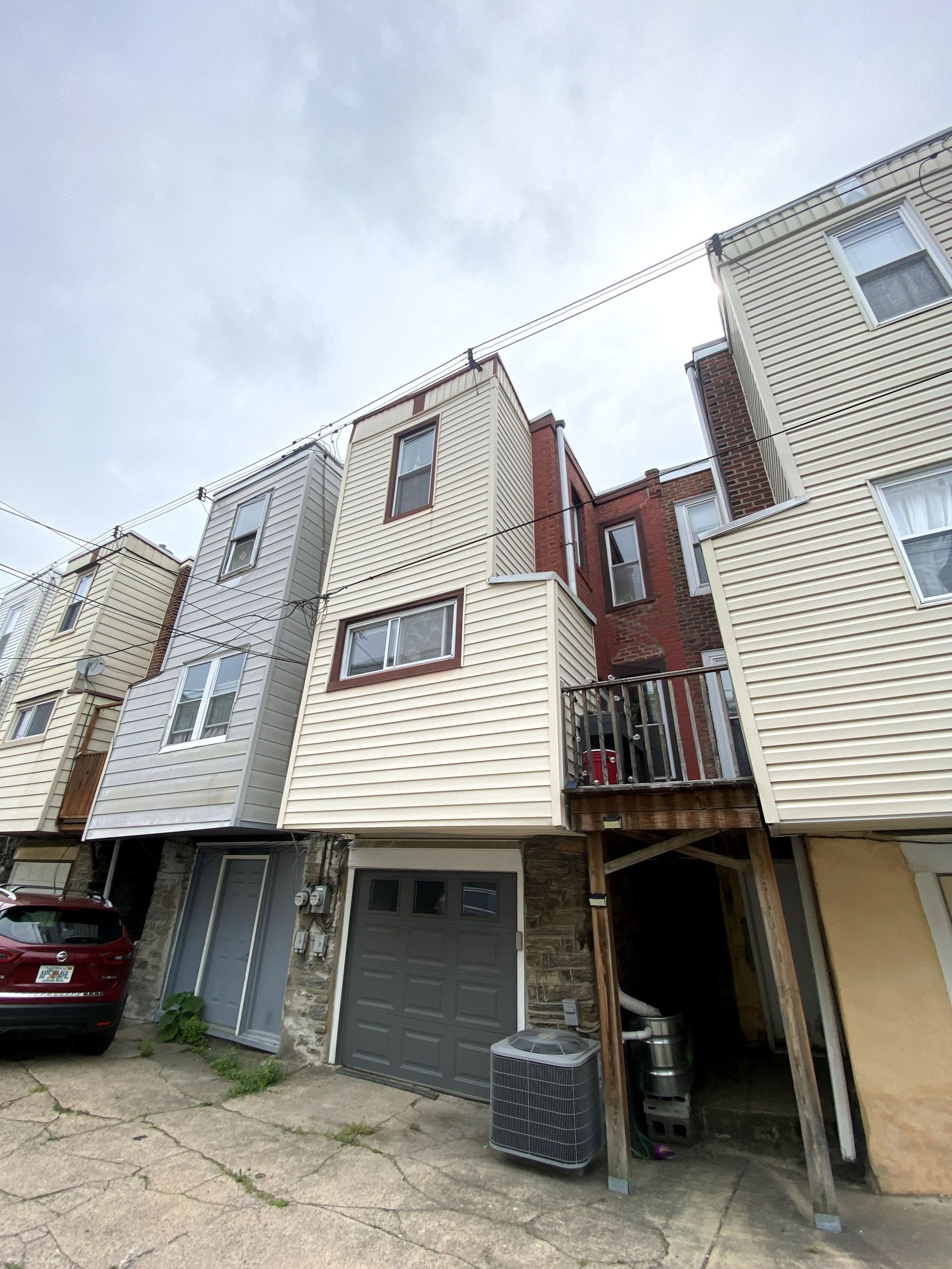 A row of houses with a car parked in front of them.