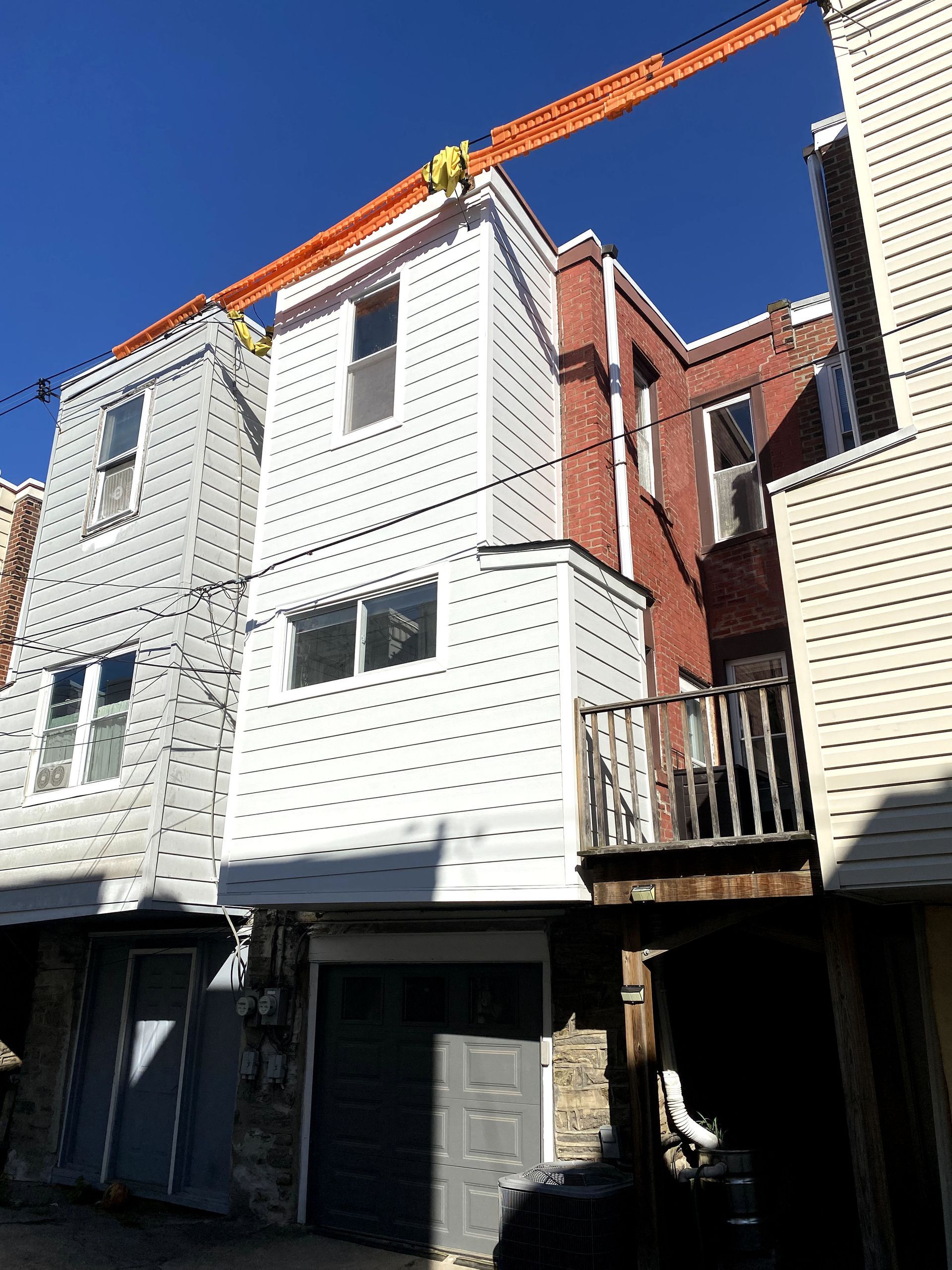 A crane is being used to remove a roof from a building