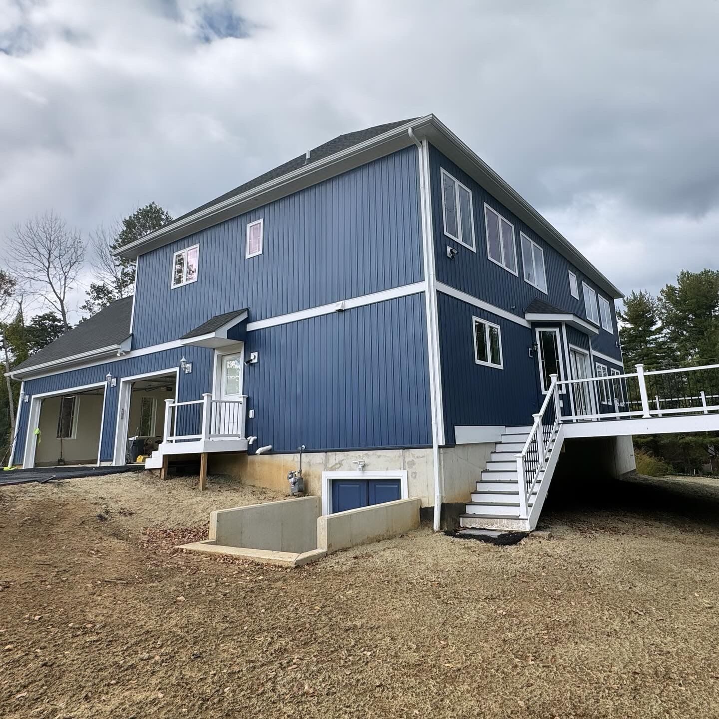 A large blue house with stairs leading up to it