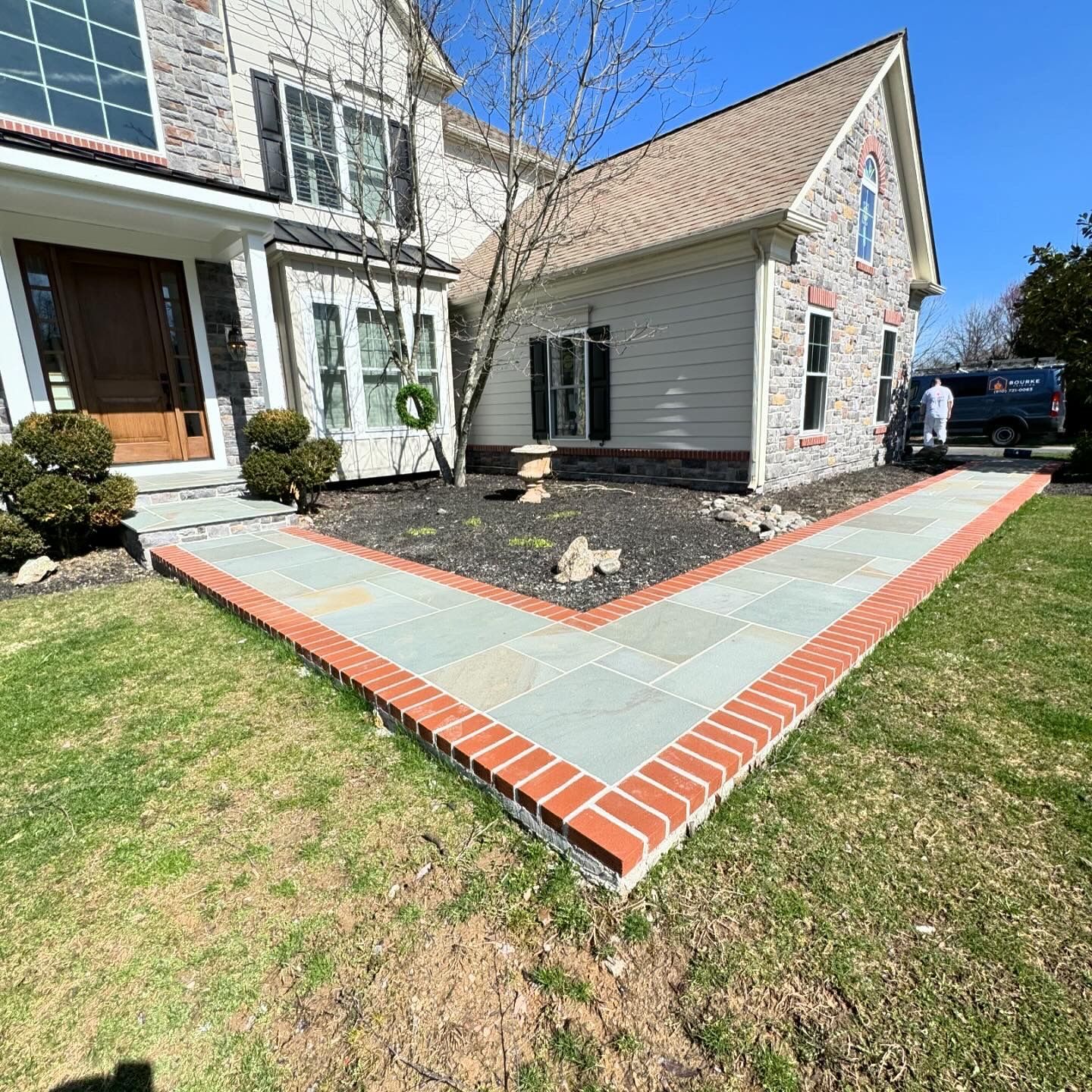 A house with a brick walkway in front of it.