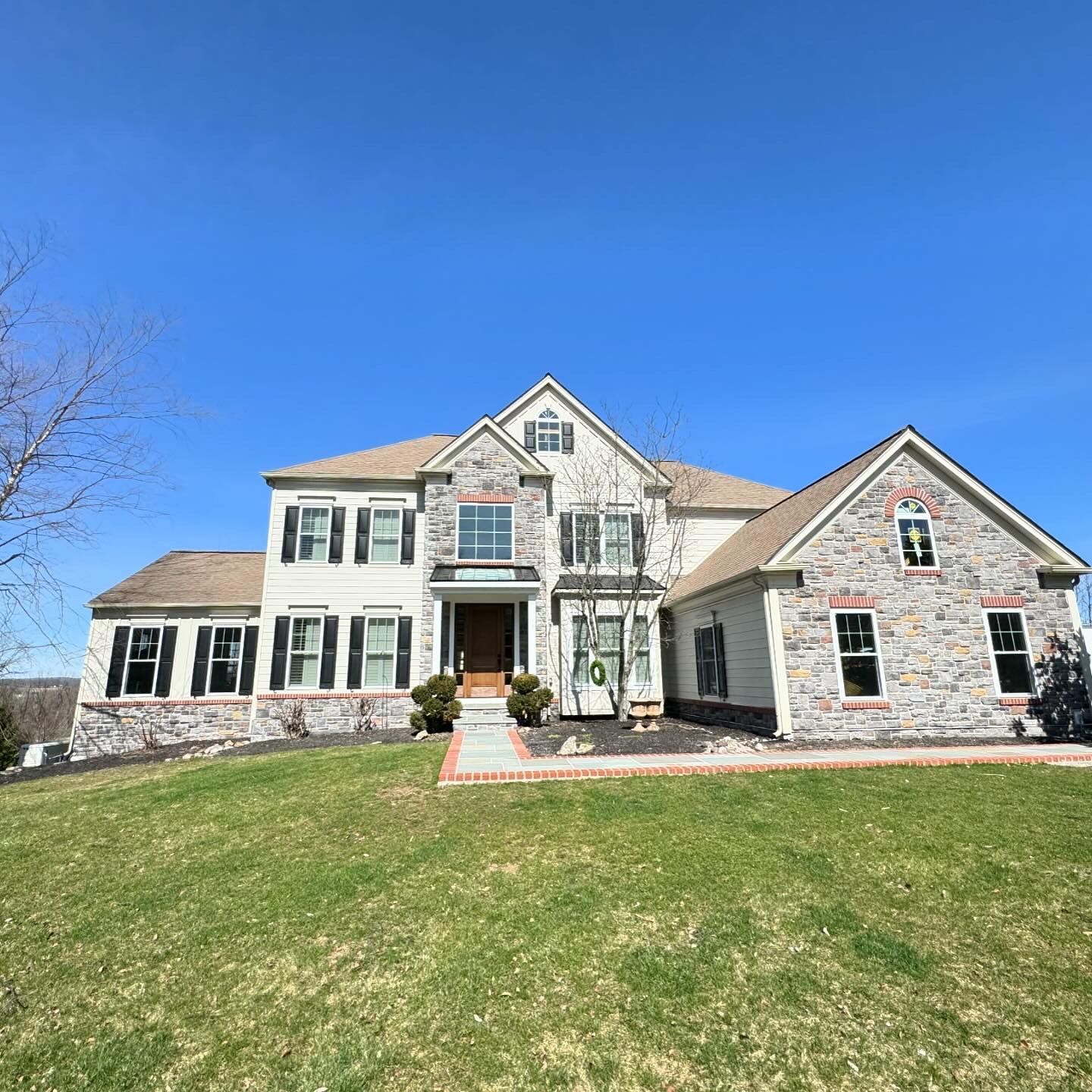 A large house with a lush green lawn in front of it.