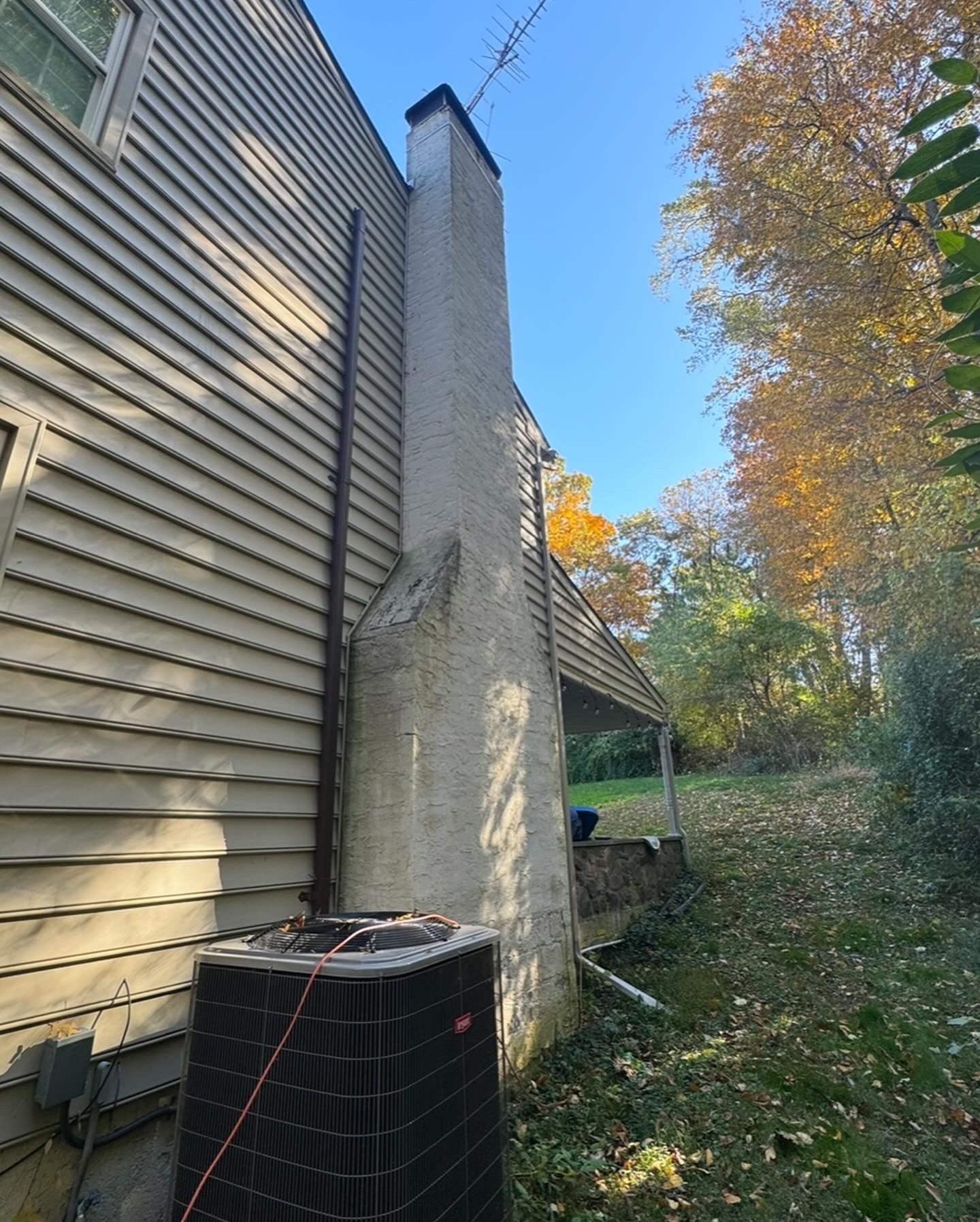 A house with a chimney on the side of it