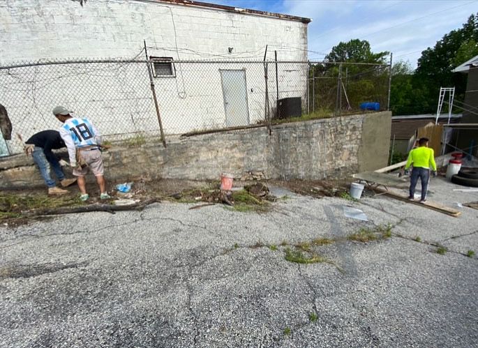 A group of people are working on the side of a building.