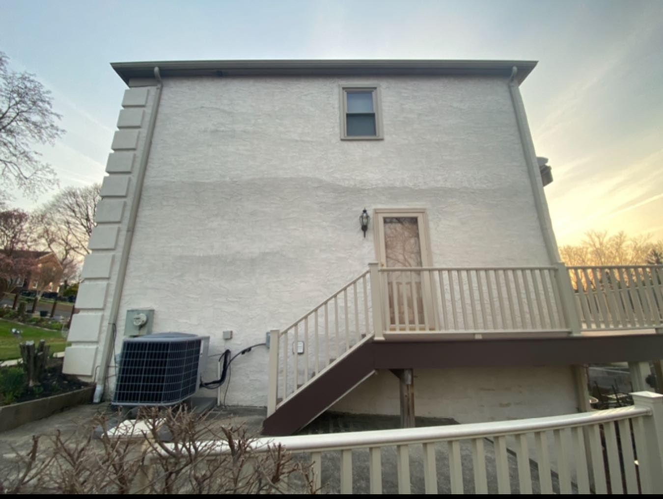 The back of a house with stairs leading up to it
