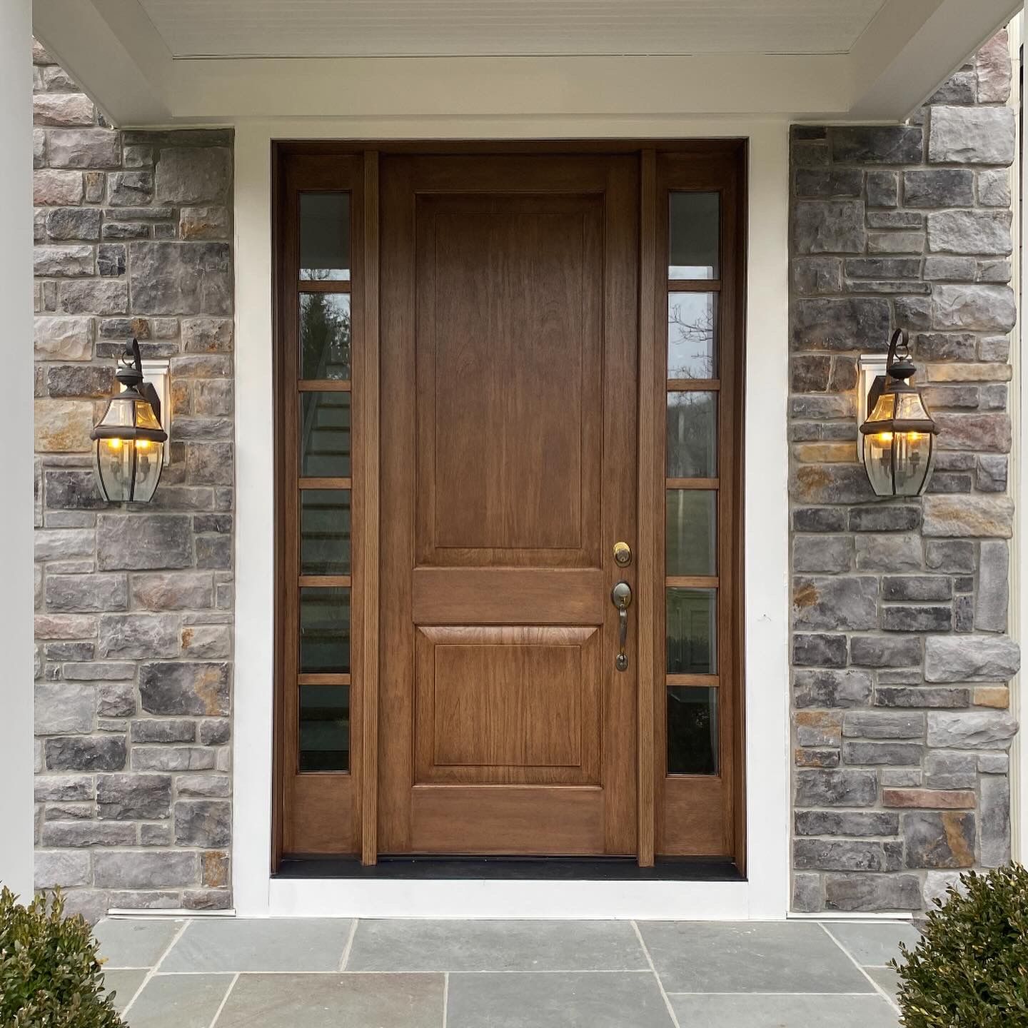 A wooden door with a stone wall behind it