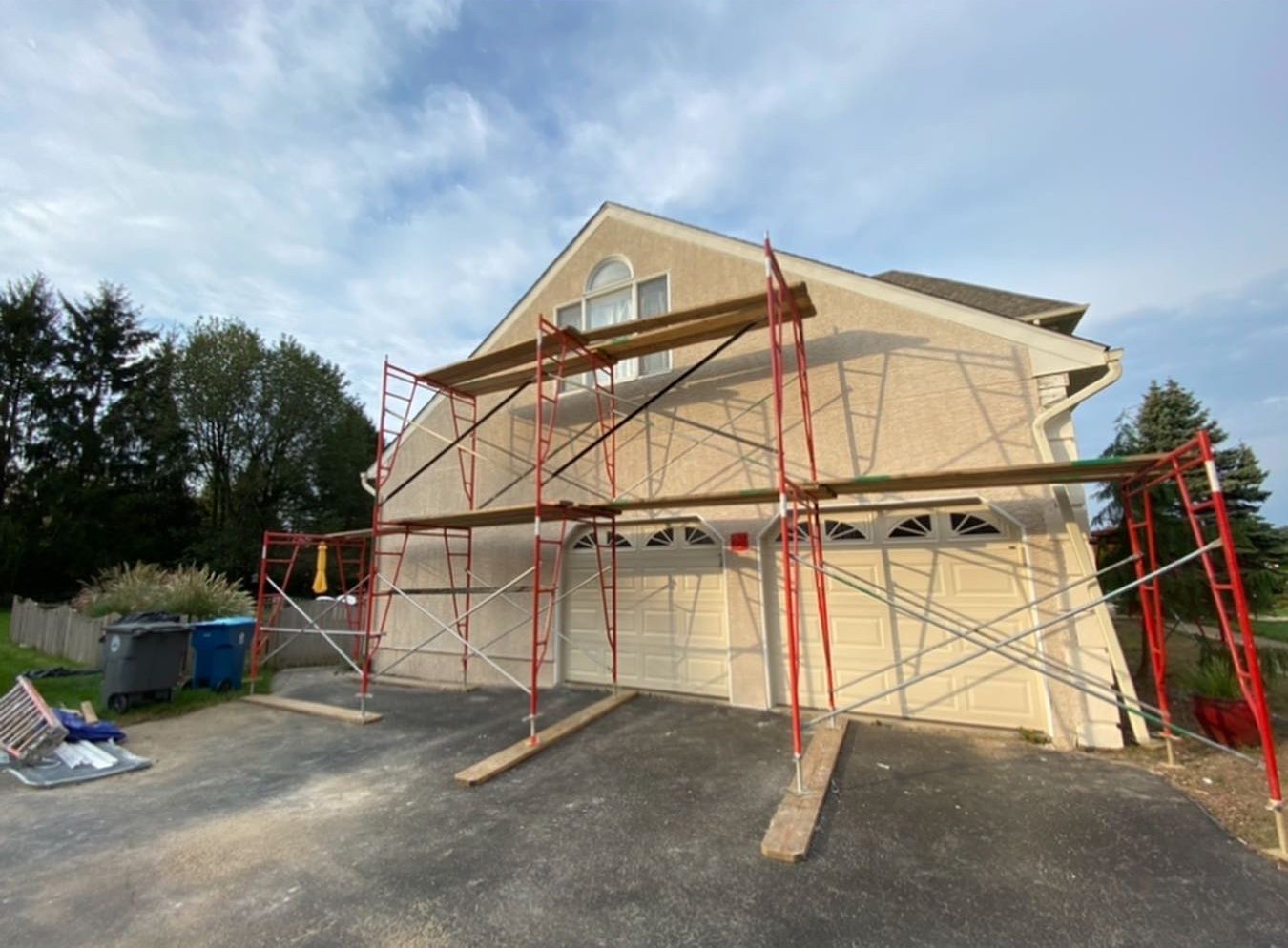 A house with scaffolding around it is being painted.