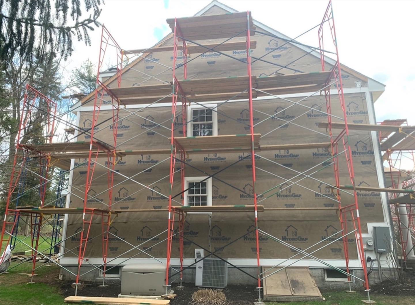A house is being remodeled with scaffolding around it.