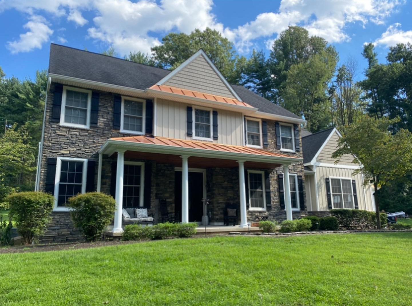 A large house with a large lawn in front of it.