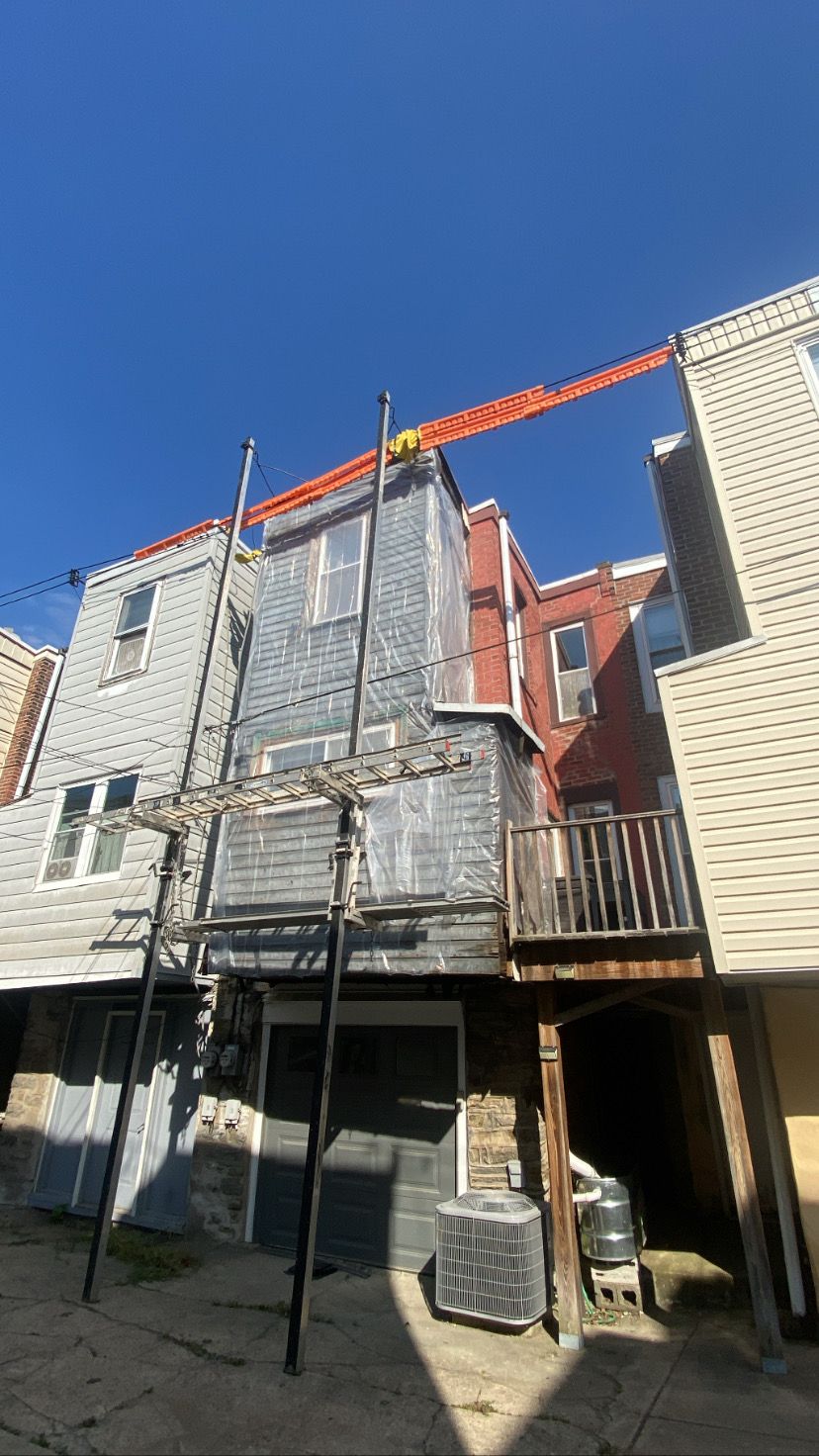 A building with a crane on top of it is being remodeled.