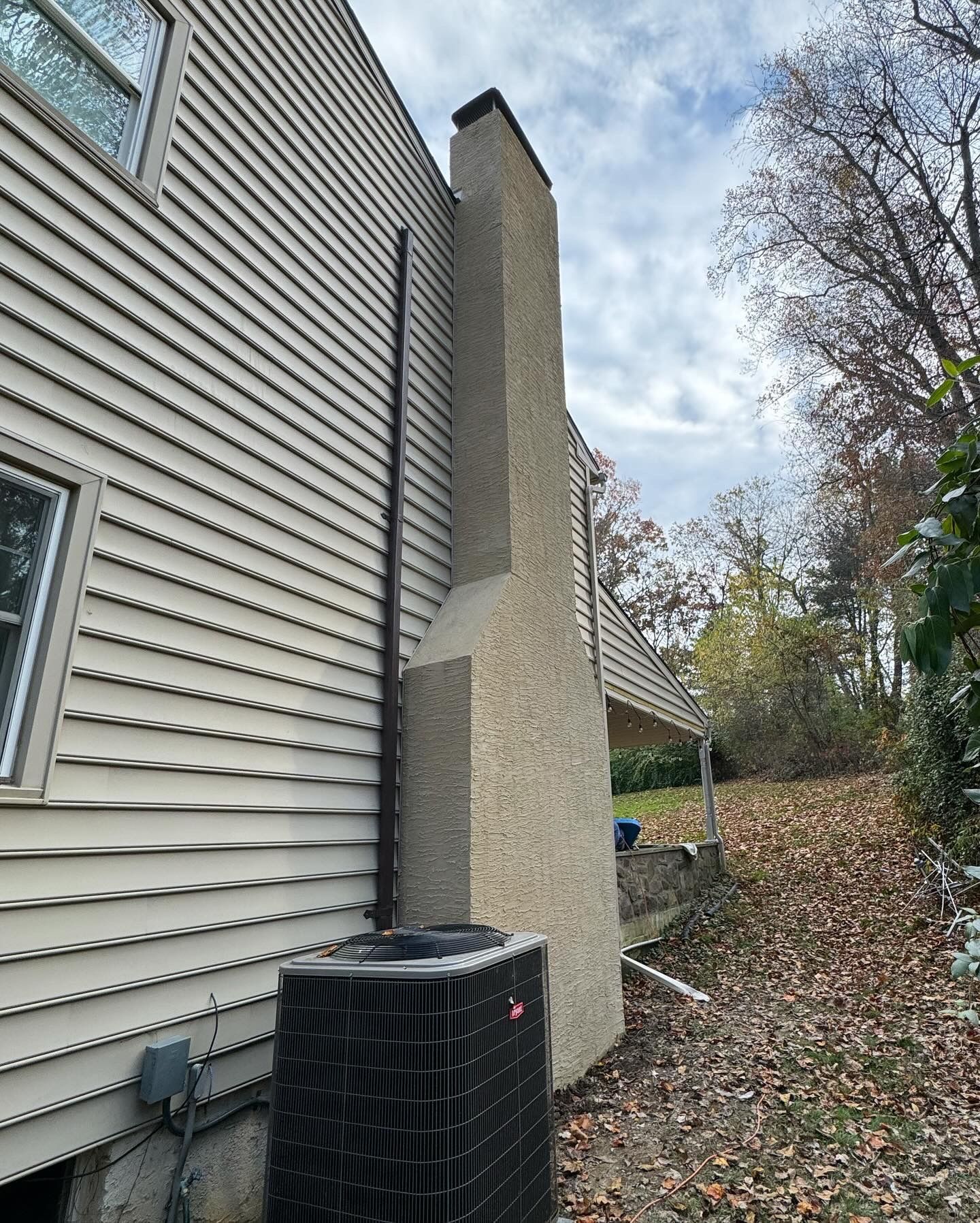 A house with a chimney on the side of it.