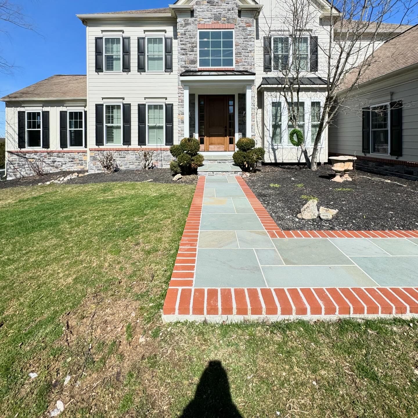 A large white house with a brick walkway leading to it