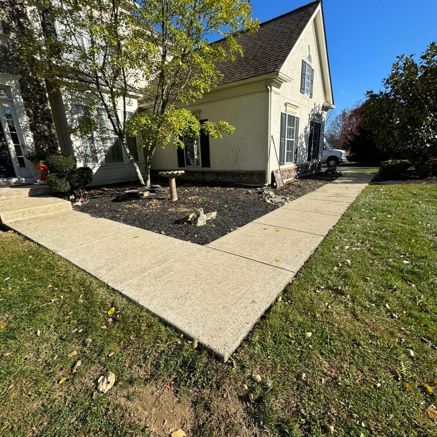 A white house with a sidewalk in front of it