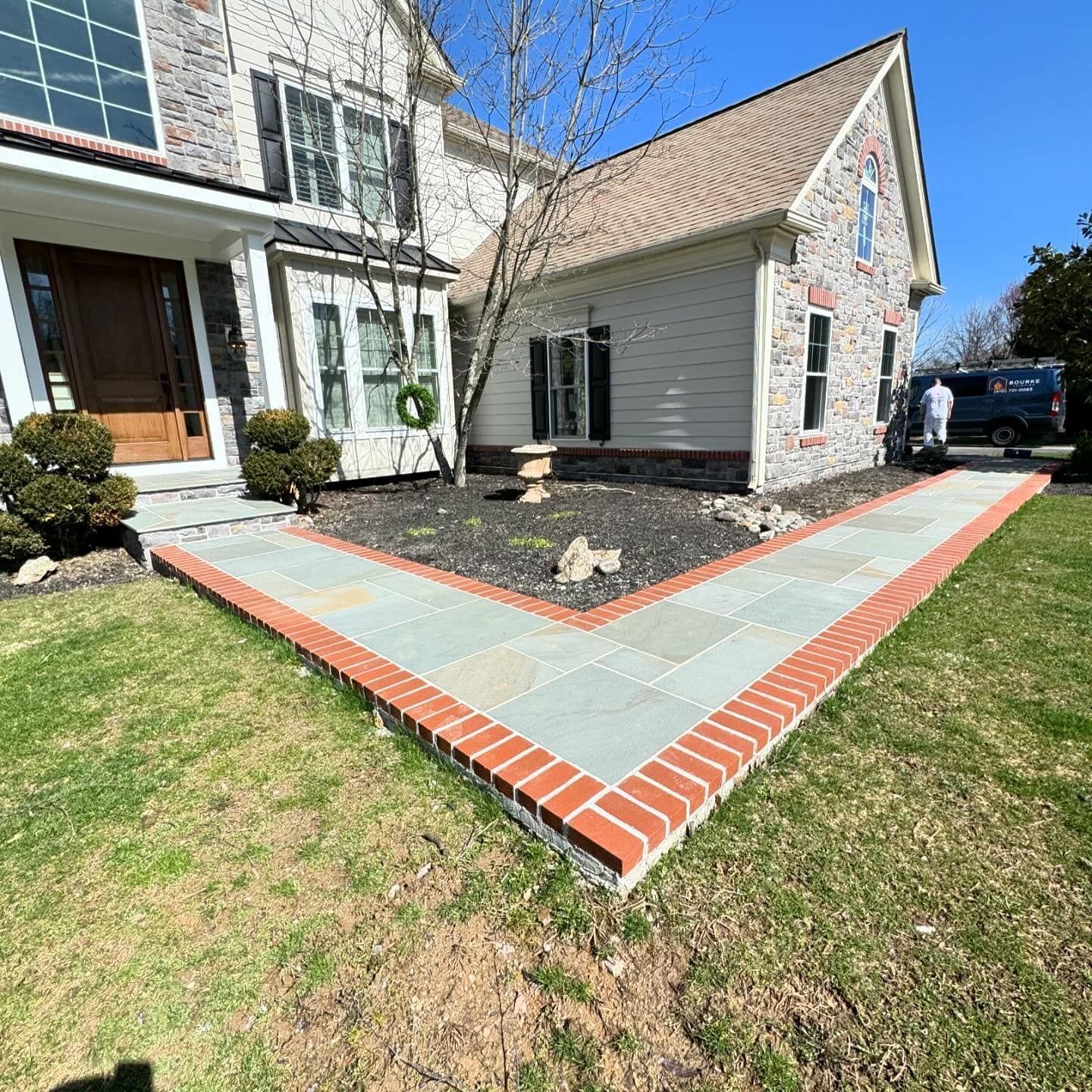 A house with a brick walkway in front of it