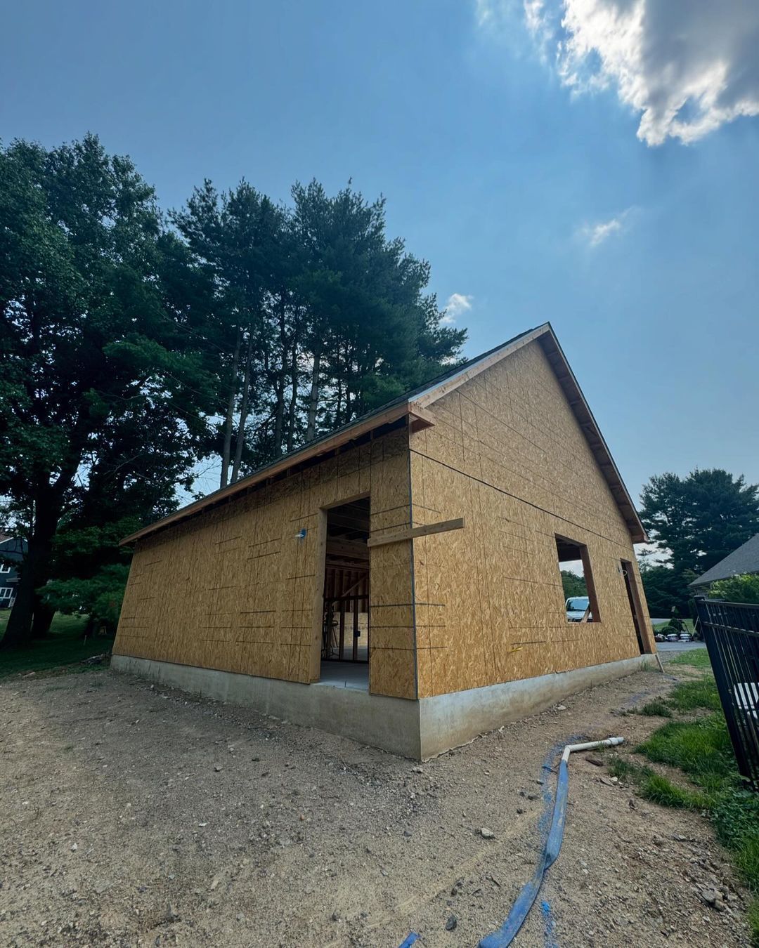 A house is being built in the middle of a dirt field