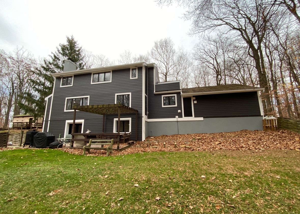 The back of a house with a deck and stairs- after