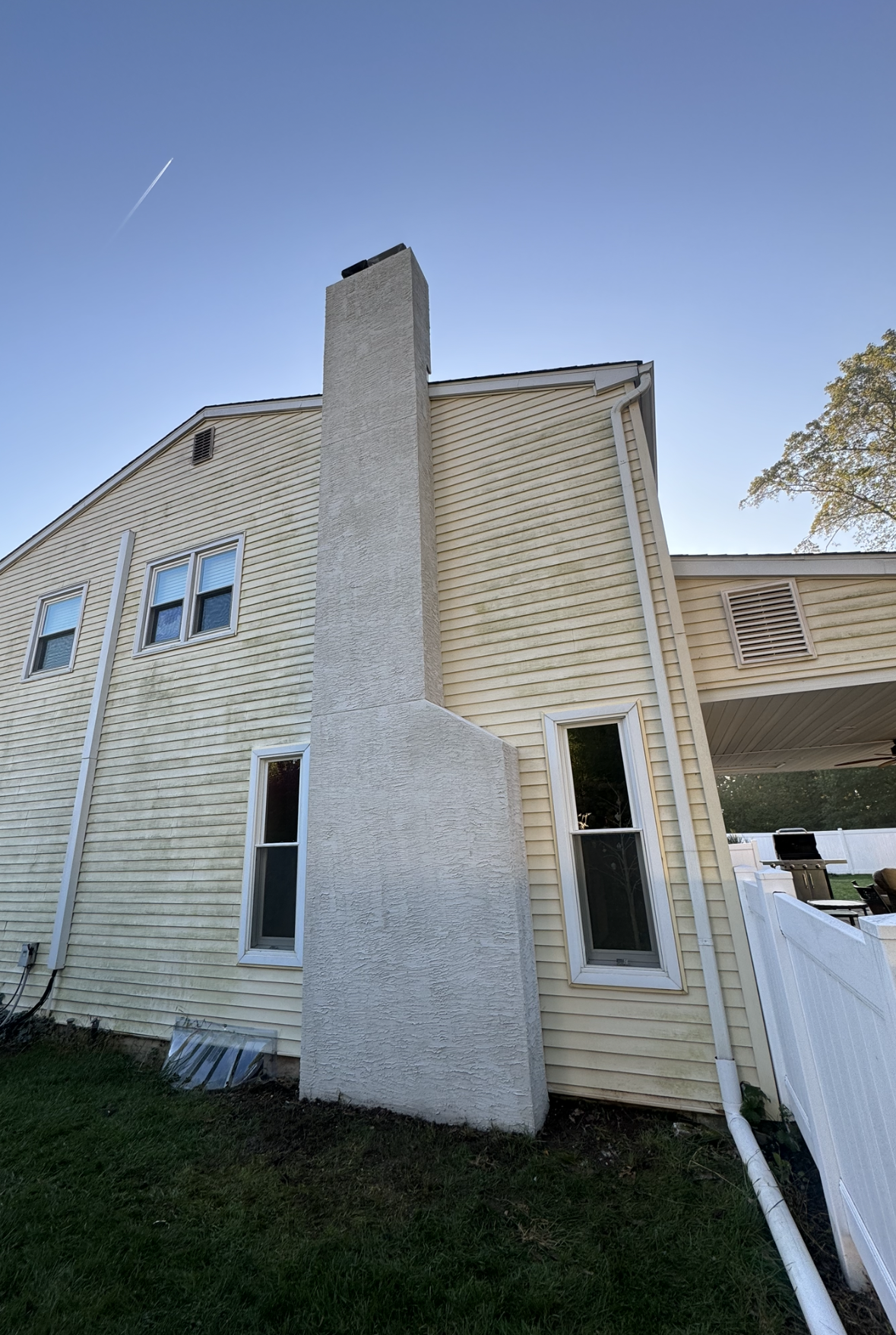 A chimney is on the side of a house.