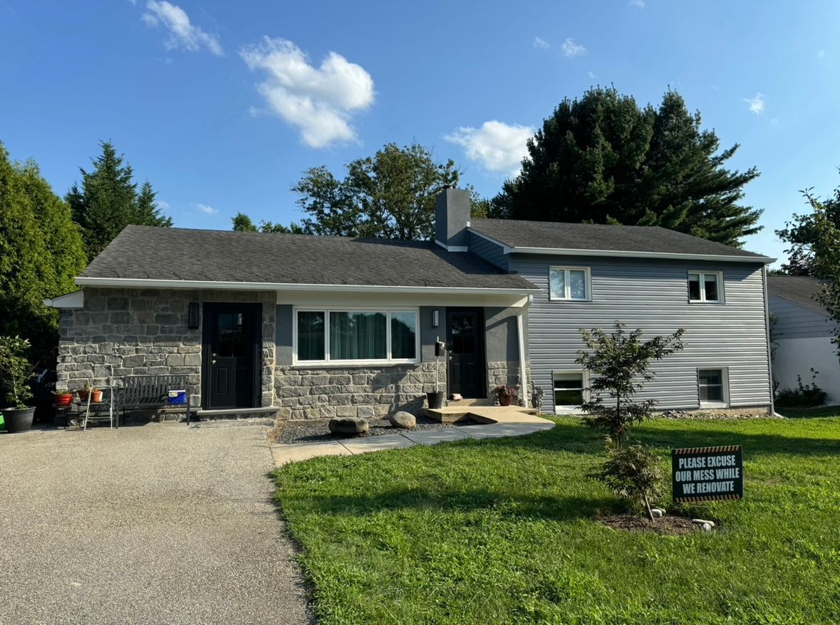 A house with a sign in front of it that says 