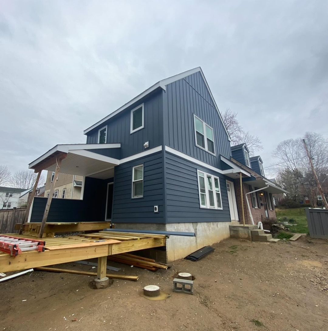 A blue house with a ramp attached to it is being built.