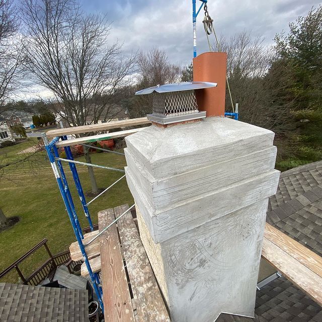 A chimney is sitting on top of a wooden scaffolding on a roof.