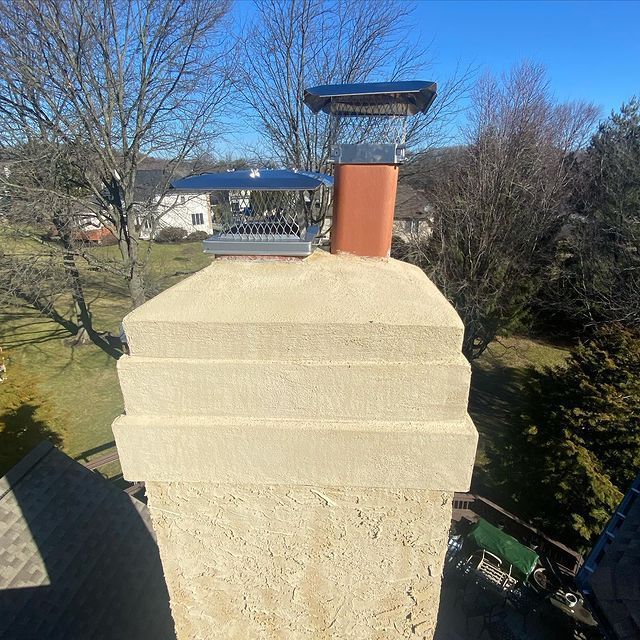 An aerial view of a chimney with a bird feeder on top of it.