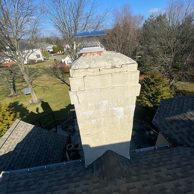 An aerial view of a chimney on the roof of a house.