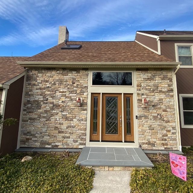 A house with a stone facade and a wooden door