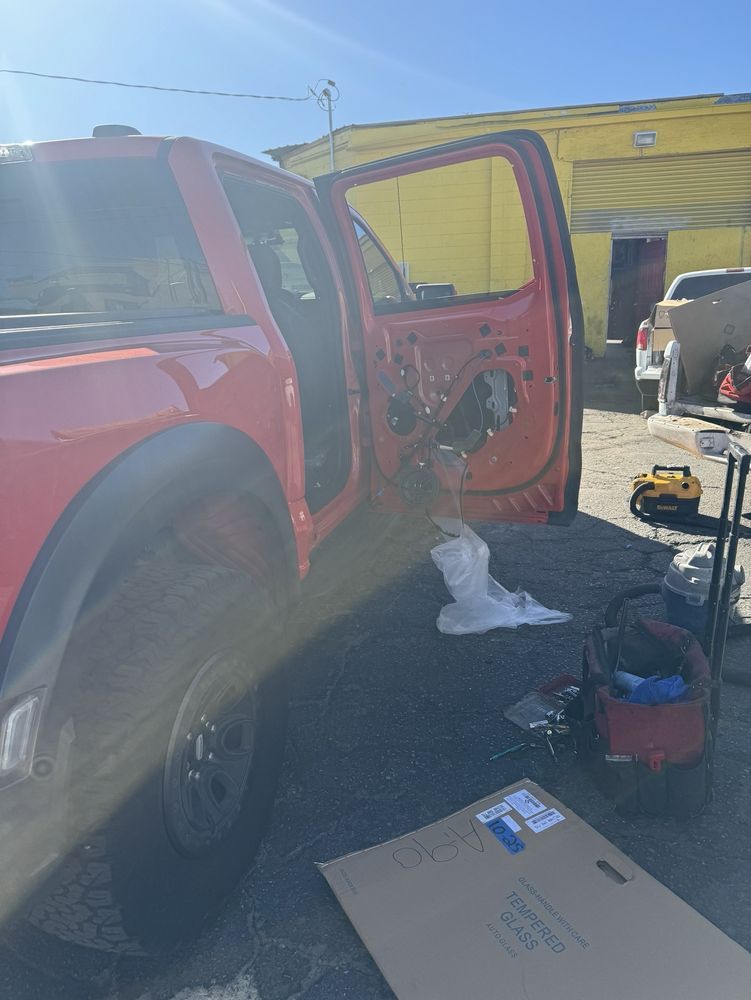man repairing car glass and other mechanical parts