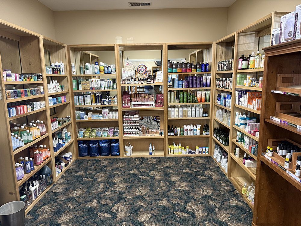 A room with shelves filled with various beauty and health products, set on patterned carpet.