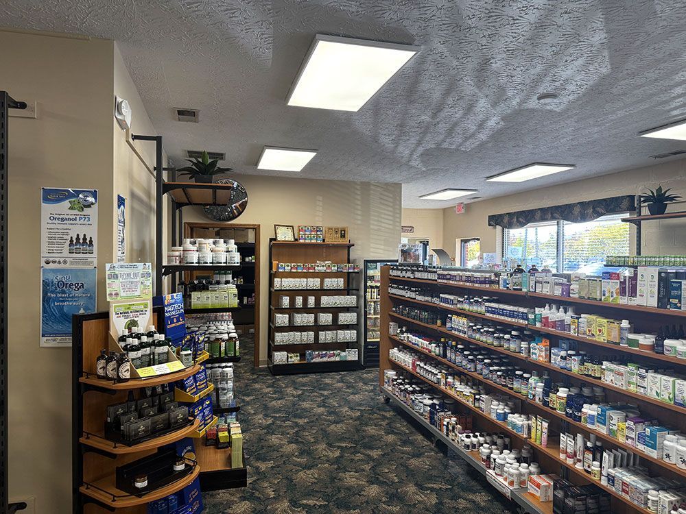 Interior of a health store with shelves of supplements, products on display, and overhead lighting.