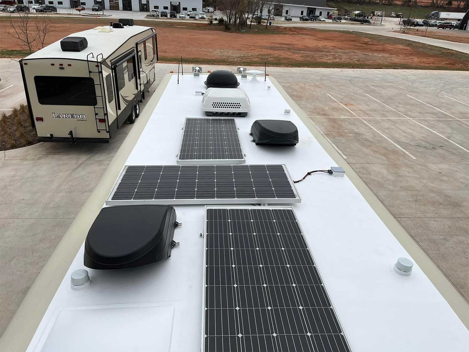A white rv with solar panels on the roof