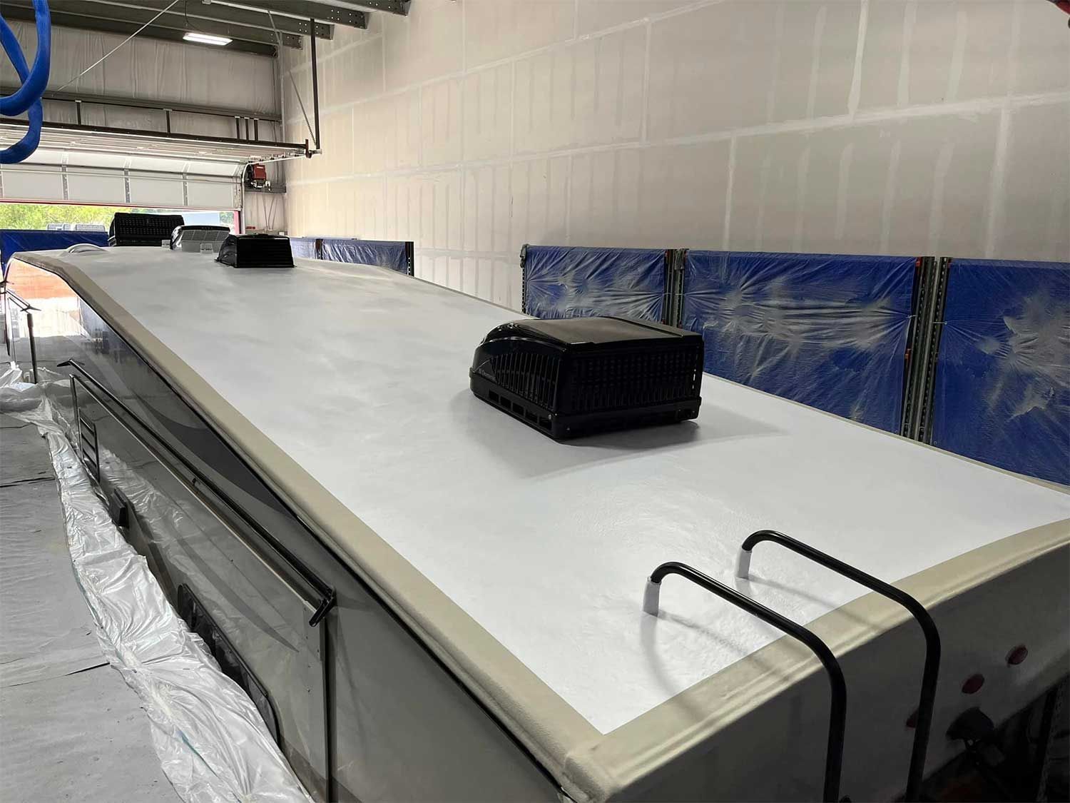 A white roof with a black box on top of it in a garage.