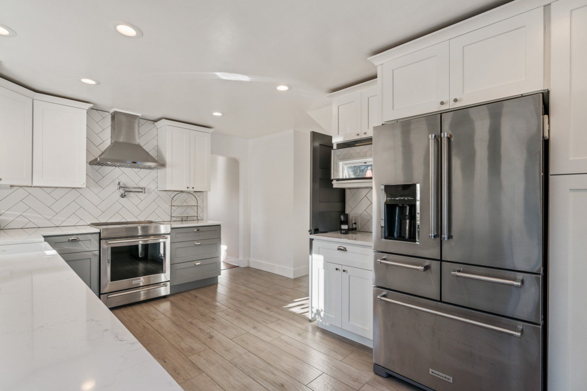 A kitchen with stainless steel appliances and white cabinets