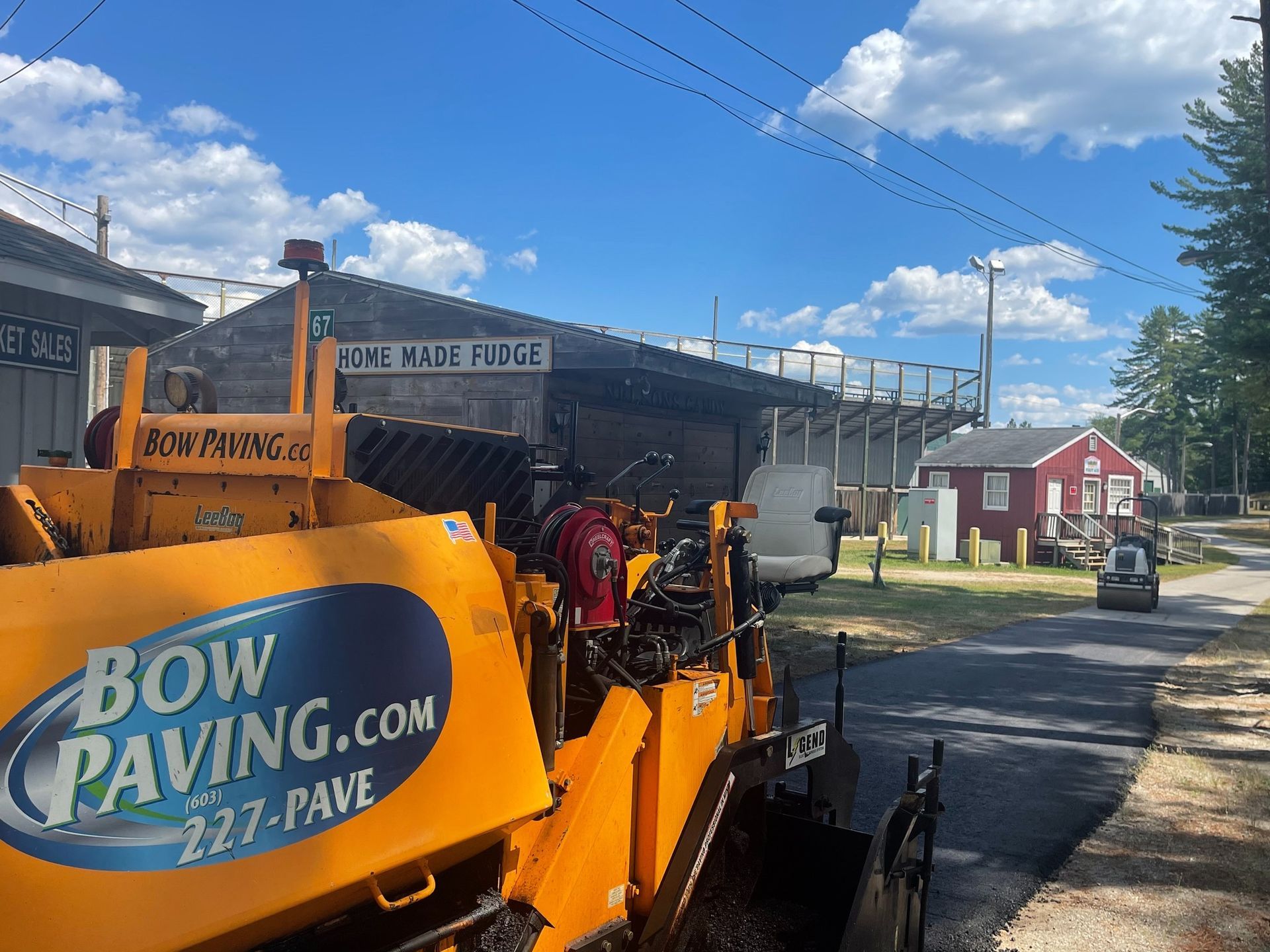 A yellow asphalt paver marked 