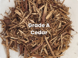 Pile of brown cedar mulch labeled “Grade A Cedar”