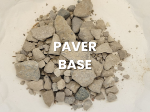 Pile of gray paver base gravel with the words “PAVER BASE” overlaid.