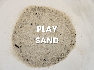 White text reading “PLAY SAND” on a light tan sand pile