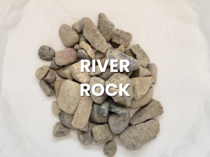 Pile of small gray and tan river rocks with the text “RIVER ROCK” overlaid